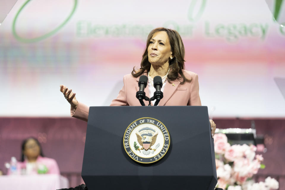 Kamala Harris, wearing a coral pink suit, speaks onstage for the vice presidential candidate at an Alpha Kappa Alpha sorority event in Dallas in July.