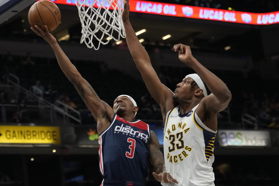 Washington Wizards guard Bradley Beal (3) shoots in front of Indiana Pacers center Myles Turner (33) during the first half of an NBA basketball game in Indianapolis, Monday, Dec. 6, 2021. (AP Photo/AJ Mast)