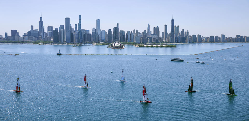 In this image provided by SailGP, the F50 catamaran fleet sail past the Chicago skyline ahead of United States Sail Grand Prix sailing race on Lake Michigan, Saturday, June 18, 2022, in Chicago. (Simon Bruty/SailGP via AP)