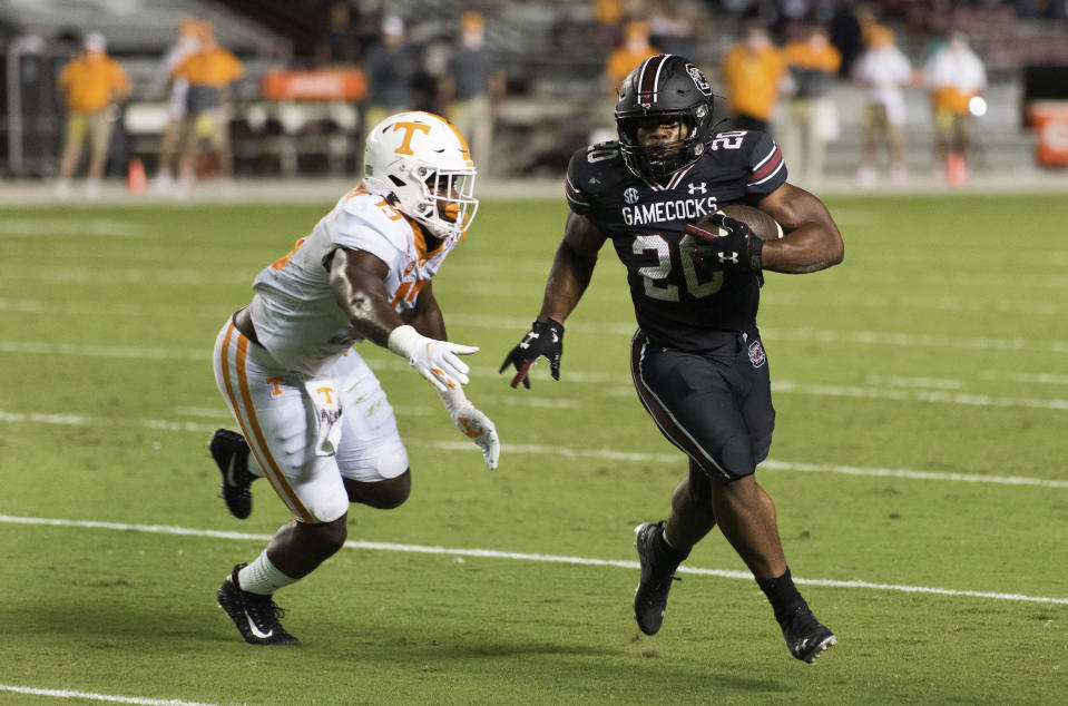 South Carolina running back Kevin Harris (20) carries for a touchdown, next to Tennessee linebacker Deandre Johnson (13) during the first half of an NCAA college football game Saturday, Sept. 26, 2020, in Columbia, S.C. (AP Photo/Sean Rayford)