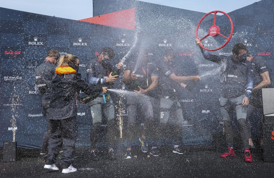 In this photo provided by SailGP, the Britain SailGP Team presented by INEOS, helmed by Sir Ben Ainslie, celebrate after winning the final race on race Day 2 of the Bermuda SailGP event in Hamilton, Bermuda, Sunday, April 25, 2021. (Thomas Lovelock/SailGP via AP)