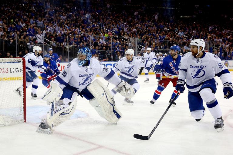 Ben Bishop (L) of the Tampa Bay Lightning tends net duirng the game against the New York Rangers in Game Five of the Eastern Conference Finals at Madison Square Garden on May 24, 2015