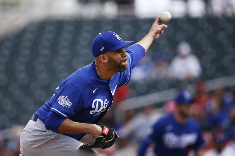 FILE - In this March 2, 2020, file photo, Los Angeles Dodgers starting pitcher David Price throws against the Cincinnati Reds during the first inning of a spring training baseball game in Goodyear, Ariz. Price, Buster Posey, Marcus Stroman and more than a dozen other players who opted out of the pandemic-shortened 2020 season get back to work this week. They not only will have to deal with rust but the demands of MLB’s coronavirus safety protocols. (AP Photo/Ross D. Franklin, File)