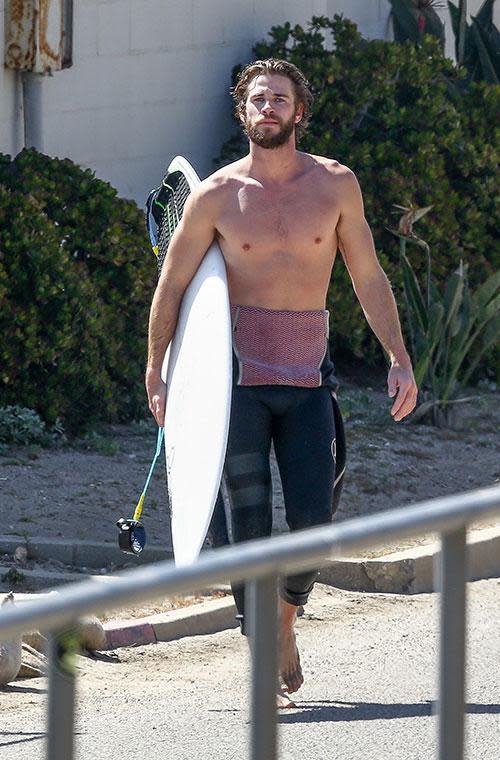 Liam Hemsworth bares all before a day in the surf