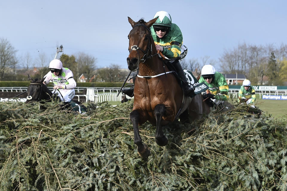 Rachael Blackmore ridding Minella Times clears the last fence to win the Randox Grand National Handicap Chase on the third day of the Grand National Horse Racing meeting at Aintree racecourse, near Liverpool, England, Saturday April 10, 2021. (Peter Powell/Pool via AP)