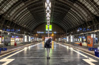 A man checks his mobile phone in the central train station in Frankfurt, Germany, Friday, Dec. 8, 2023, when train drivers of the GDL union went on a 24-hour-strike. (AP Photo/Michael Probst)