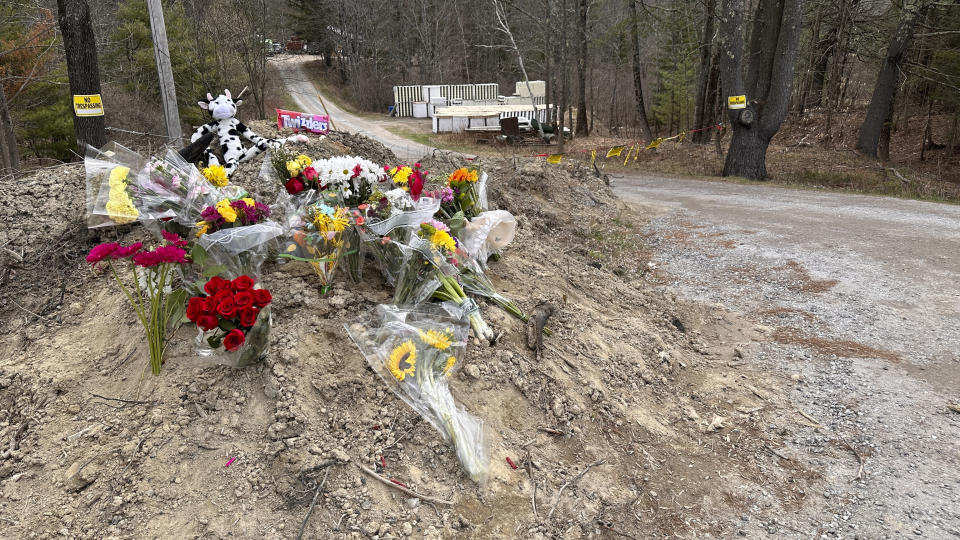 A makeshift memorial for Patricia Eger and her husband, Bob Eger, is seen at the end of a long driveway to their home in Bowdoin, Maine, Friday, April 21, 2023. The two were found several days earlier, slain in a violent rampage. (AP Photo/Rodrique Ngowi)
