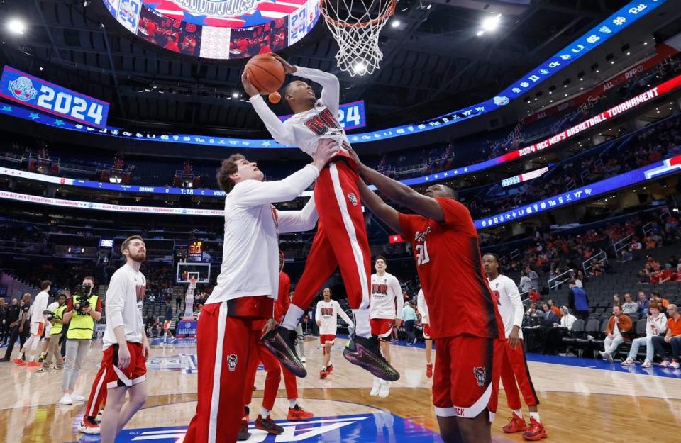 N.C. State’s Ben Middlebrooks and DJ Burns Jr. lift up KJ Keatts to slam in two as they finish warming up before the Wolfpack’s game against Syracuse in the second round of the 2024 ACC Men’s Basketball Tournament at Capital One Arena in Washington, D.C., Wednesday, March 13, 2024.