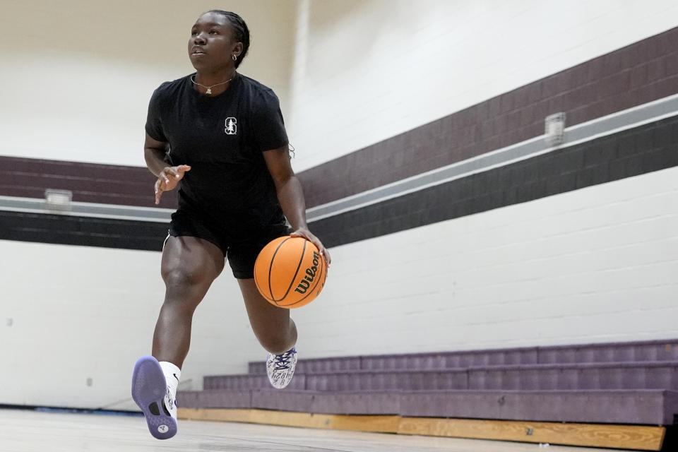 Shay Ijiwoye, who played basketball at Desert Vista High in Phoenix and has committed to Stanford University, works out Monday, March 18, 2024, in Chandler, Ariz. Iowa’s Caitlin Clark has reshaped women's college basketball and the perception of it. Up-and-coming players have taken notice, working to extend their range to be like her. (AP Photo/Matt York)