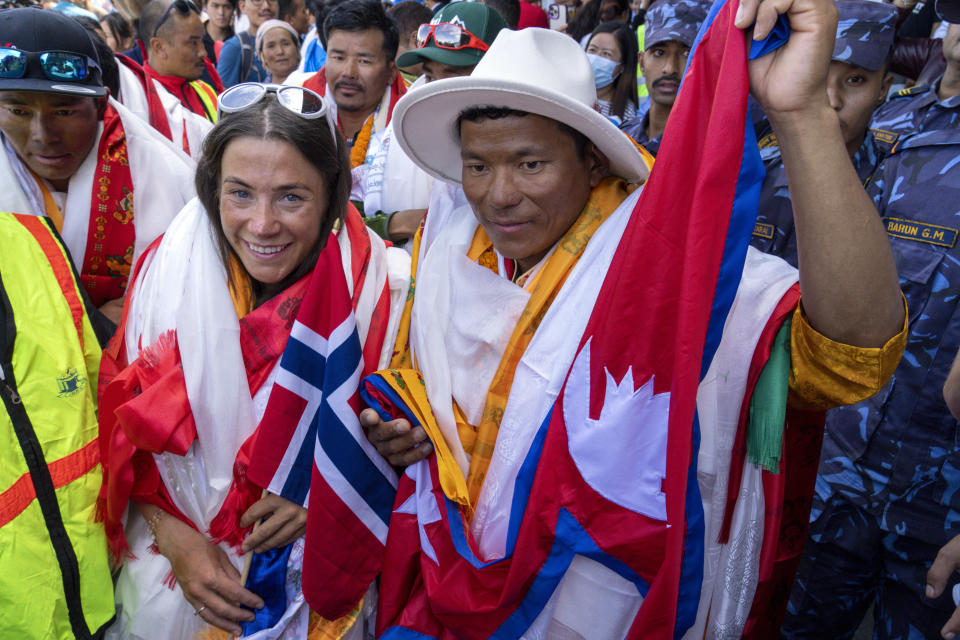 FILE - Norwegian climber Kristin Harila, left, and her Nepali sherpa guide Tenjen Sherpa, right, who climbed the world's 14 tallest mountains in record time, arrive in Kathmandu, Nepal, Saturday, Aug. 5, 2023. A Pakistani mountaineer said Saturday, Aug. 12, 2023, that an investigation has been launched into the death of a Pakistani porter during Harila's record quest. (AP Photo/Niranjan Shrestha, File)