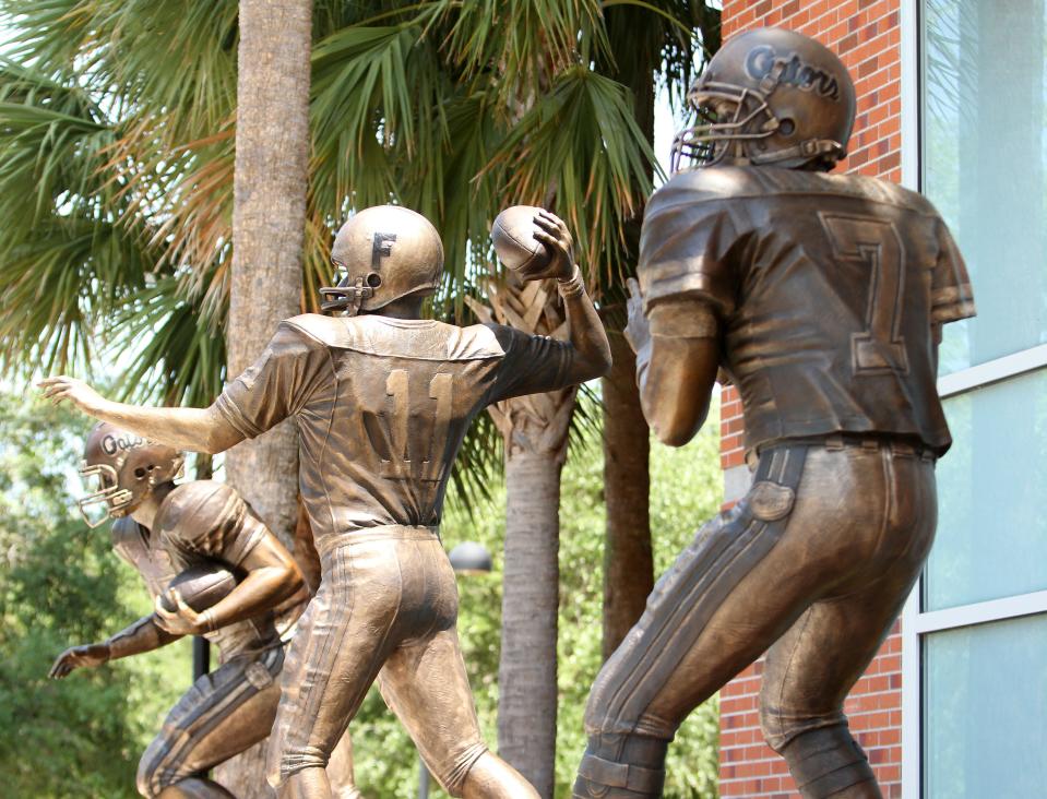 The statues of former Florida quarterbacks and Heisman Trophy winners Tim Tebow, Steve Spurrier and Danny Wuerffel outside of Ben Hill Griffin Stadium.