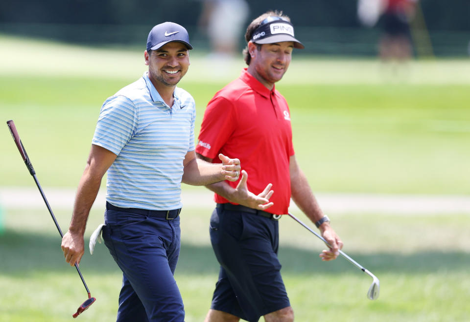 Jason Day and Bubba Watson share a laugh on the golf course.