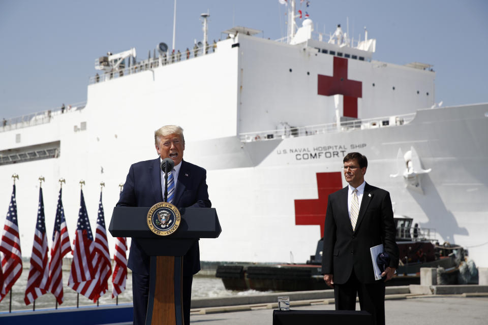 President Donald Trump speaks in front of the U.S. Navy hospital ship USNS Comfort at Naval Station Norfolk in Norfolk, Va., Saturday, March 28, 2020. The ship is departing for New York to assist hospitals responding to the coronavirus outbreak. Defense Secretary Mark Esper is at right. (AP Photo/Patrick Semansky)