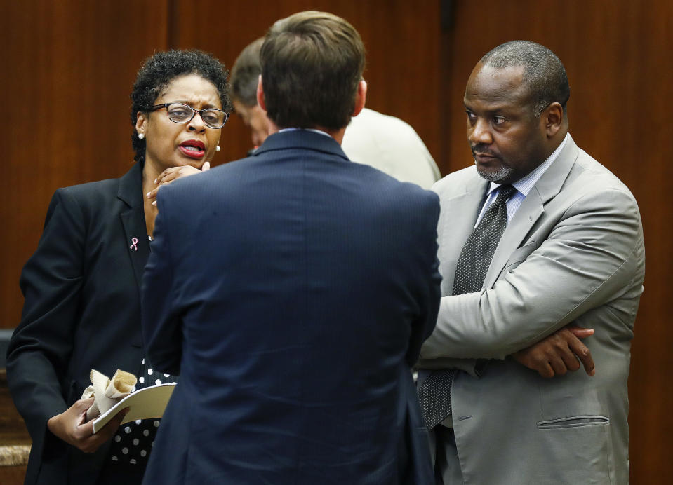 CORRECTS LAST NAME TO PALMER, NOT PALMERON - Defense attorneys Darla Palmer, left, and Alton Peterson, right, chats with Deputy Prosecutor Jay Hale, center, during the retrial of Quinton Tellis in Batesville, Miss., on Wednesday, Sept. 26, 2018. Tellis is charged with burning 19-year-old Jessica Chambers to death in December 2014. Tellis has pleaded not guilty to the murder. (Mark Weber/The Commercial Appeal via AP, Pool)