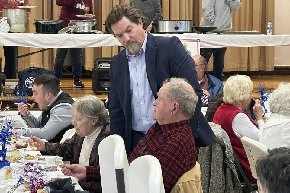 In this image provided by the Committee to Elect Michael Kripchak, Democratic candidate for Congress, Michael Kripchak, standing, meets with supporters on Feb. 18, 2024, at the Monroe County, Ohio, Democratic Party, Pre-Primary Baked Steak Dinner. Kripchak faces Republican state Sen. Michael Rulli in the Tuesday, June 11, 2024, special election for the U.S. House seat in Ohio's 6th District. The seat has been vacant since longtime U.S. Rep. Bill Johnson resigned in January to become a university president. (Committee to Elect Michael Kripchak via AP)