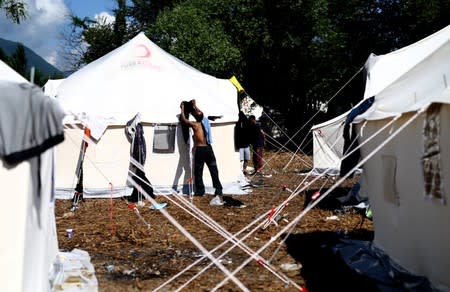 Migrants wait for food in the migrant camp Vucjak in Bihac area