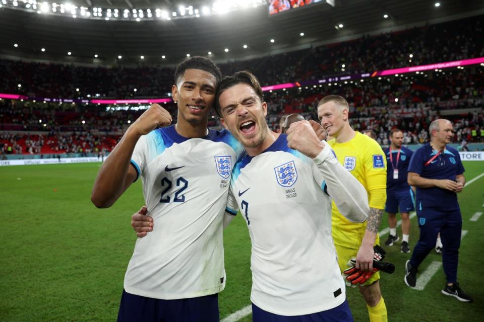 Jude Bellingham and Jack Grealish celebrate after beating Wales (The FA/Getty)