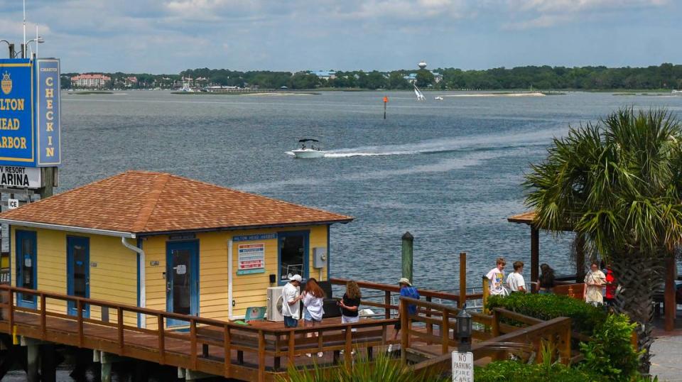 Photographed from within the clubhouse at Hilton Head Harbor RV Resort and Marina, an abandoned sailboat’s mast can be seen rising from the waters of Skull Creek just above the wake created by the passing motorboat as photographed on May 20, 2024 on Jenkins Island.