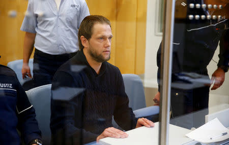 FILE PHOTO: Salafist preacher Sven Lau appears behind a bullet-proof window at a high-security courtroom in Duesseldorf, Germany April 25, 2017. REUTERS/Wolfgang Rattay/File Photo