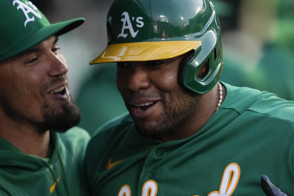 Oakland Athletics' Jesus Aguilar, right, celebrates in the dugout after a home run during the third inning of a baseball game against the Los Angeles Angels in Anaheim, Calif., Monday, April 24, 2023. (AP Photo/Ashley Landis)
