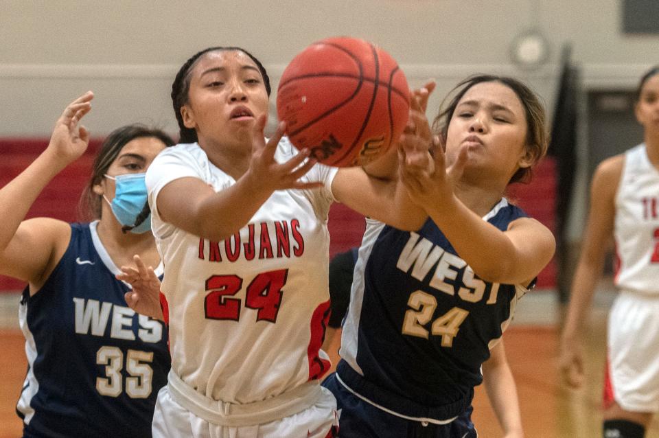 Lincoln's Amya Griffin, left, fights for a rebound with West's Jaylin Delgado during a girl's varsity basketball game at Lincoln High School in Stockton.