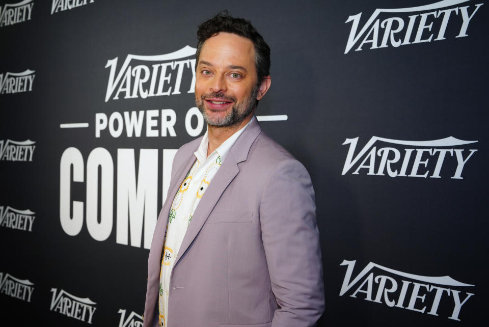 Nick Kroll poses at Variety's Power of Comedy event wearing a light jacket and patterned tie