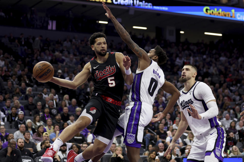 Portland Trail Blazers guard Skylar Mays, 5, passes against Sacramento Kings guard Malik Monk (0) during the first half of an NBA basketball game in Sacramento, Calif, Wednesday, Nov. 8, 2023. (AP Photo/Jed Jacobsohn)