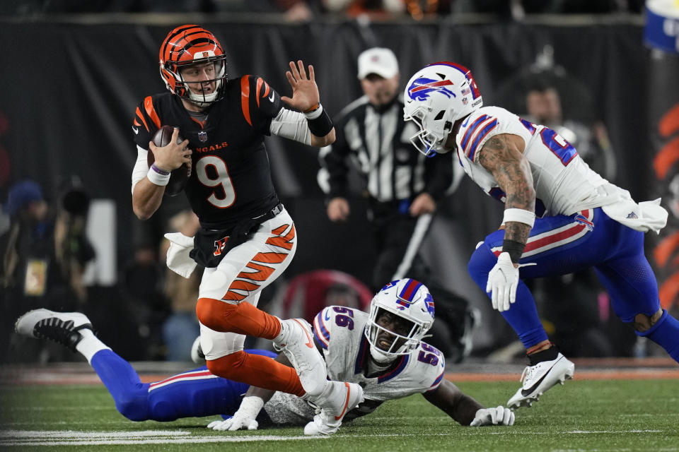 Cincinnati Bengals quarterback Joe Burrow (9) runs with the ball as Buffalo Bills defensive end Leonard Floyd (56) and safety Taylor Rapp try to stop him during the second half of an NFL football game, Sunday, Nov. 5, 2023, in Cincinnati. (AP Photo/Carolyn Kaster)