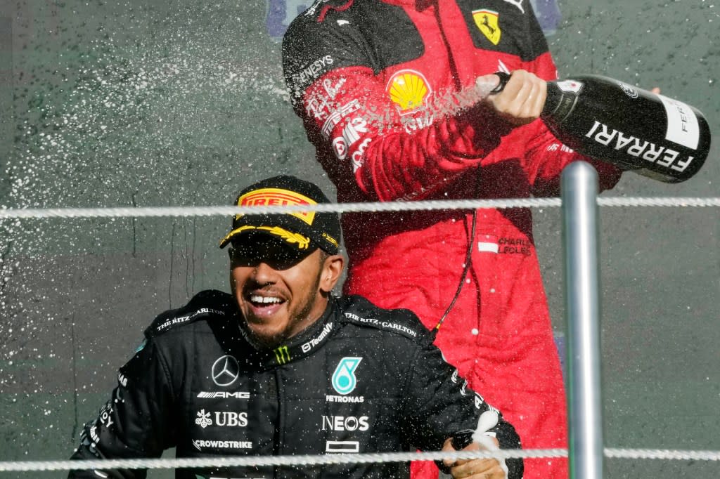 Mercedes driver Lewis Hamilton of Britain, bottom, is sprayed with champagne by Ferrari driver Charles Leclerc of Monaco on the podium for the Formula One Mexico Grand Prix auto race on Sunday, Oct. 29, 2023. (AP Photo/Fernando Llano, File)