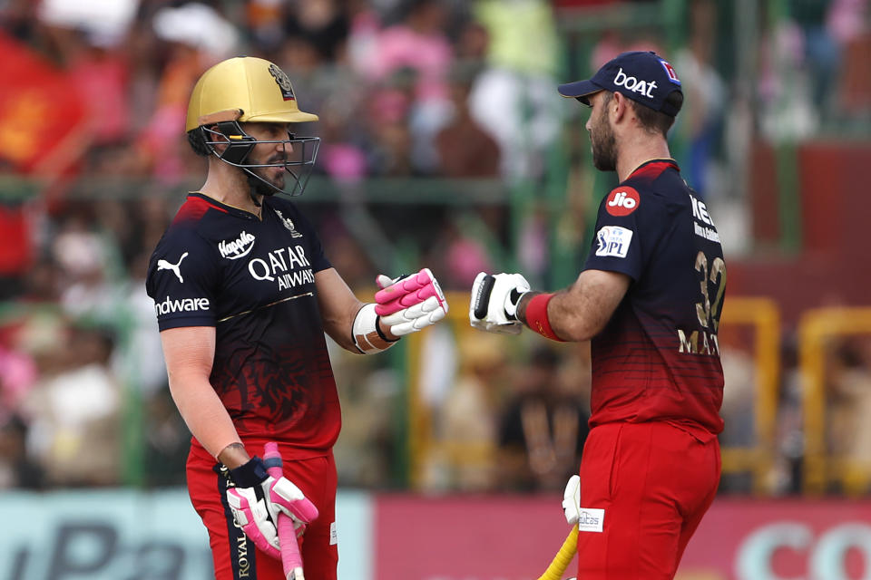 Royal Challengers Bangalore's captain Faf du Plessis, left, celebrates scoring runs with batting partner Glenn Maxwell during the Indian Premier League cricket match between Rajasthan Royals and Royal Challengers Bangalore in Jaipur, India, Sunday, May 14, 2023. (AP Photo/Surjeet Yadav)