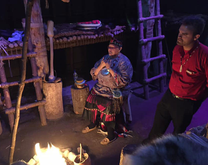 A First Nations Elder serenades us with song while huddled around a fire in a Huron-Wendat Long House (Rob Young)