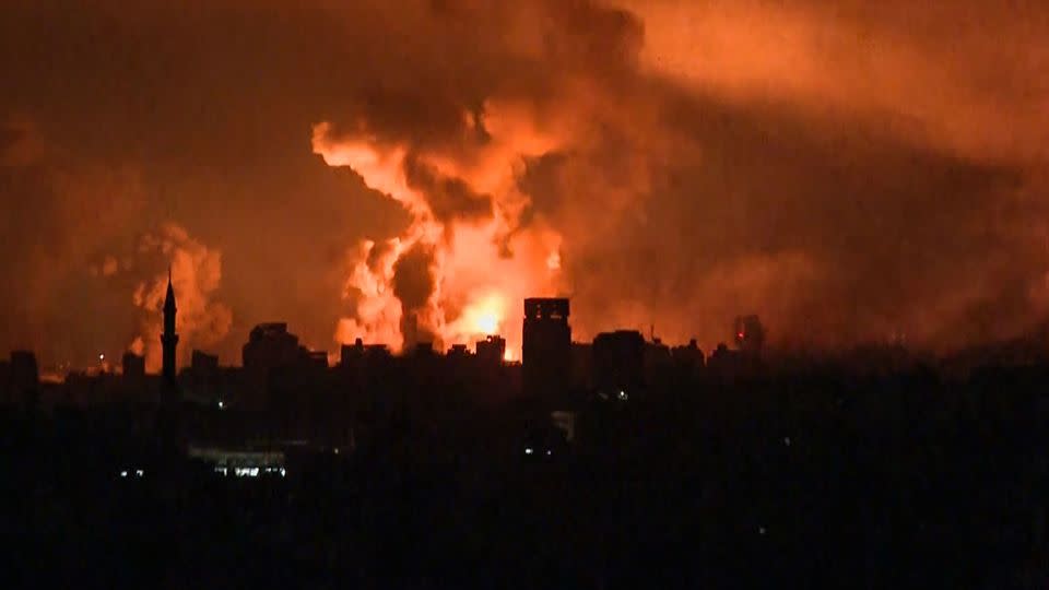 A still from AFP TV footage shows balls of fire rising above Gaza City during an Israeli strike on October 27. - AFP/Getty Images