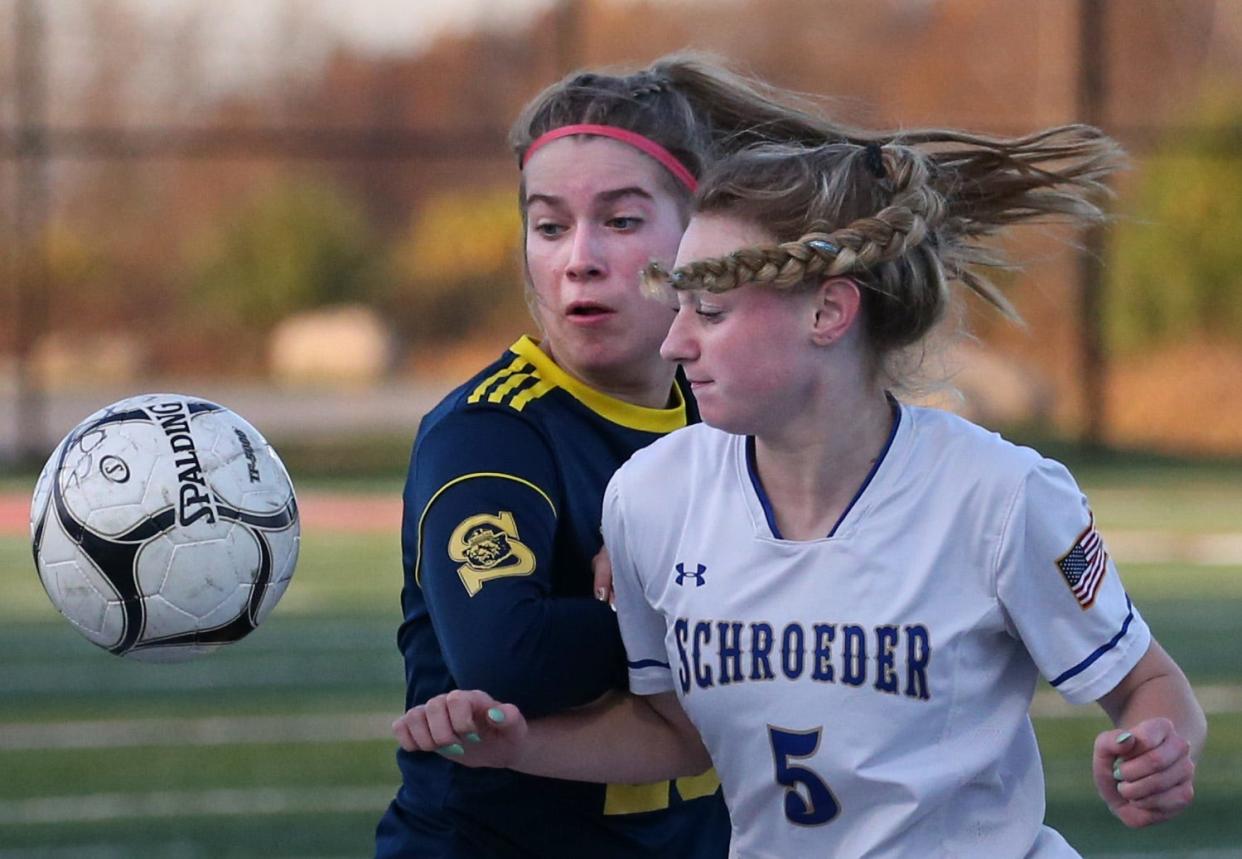 Spencerport's Emily Peacock and Schroeder's Gia Catalano battle for the ball.