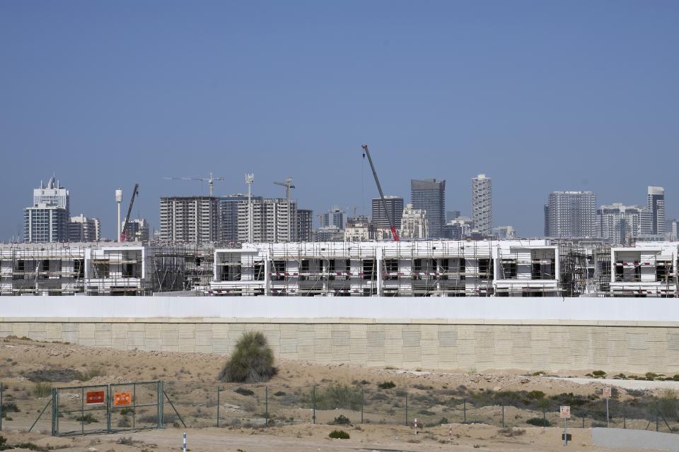 Construction goes on at a new residential development, in Dubai, United Arab Emirates, Wednesday, Feb. 1, 2023. For the first time since a 2009 financial crisis nearly brought Dubai to its knees, several major abandoned real estate projects now show signs of life. As with its other booms, war again is driving money into Dubai and buoying its economy. This time it's Russian investors fleeing Moscow’s war on Ukraine, rather than people escaping Mideast battlefields. (AP Photo/Kamran Jebreili)