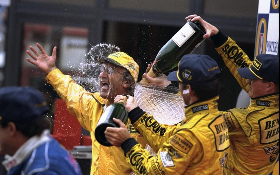 Jordan boss Eddie Jordan (left) is sprayed with champagne by winner Damon Hill (right front) of Great Britain and Ralf Schumacher (rear) of Germany both of Jordan Mugen Honda at the Belgian Grand Prix at Spa-Francorchamps in Belgium - Getty Images Sport 