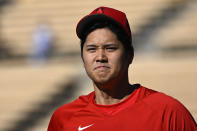 Los Angeles Angels' Shohei Ohtani walks back to the dugout after warming up prior to a preseason baseball game against the Los Angeles Dodgers Sunday, March 26, 2023, in Los Angeles. (AP Photo/Mark J. Terrill)