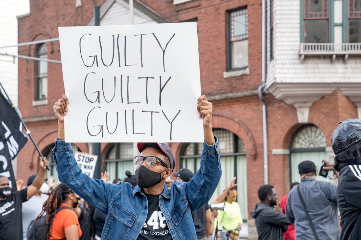 <span class="caption">In Atlanta, Ga., one person's sign reflects the actual verdicts that had just been delivered in the Derek Chauvin trial. </span> <span class="attribution"><a class="link " href="https://www.gettyimages.com/detail/news-photo/people-march-through-the-streets-after-the-verdict-was-news-photo/1232429084?adppopup=true" rel="nofollow noopener" target="_blank" data-ylk="slk:Megan Varner/Getty Images;elm:context_link;itc:0;sec:content-canvas">Megan Varner/Getty Images</a></span>