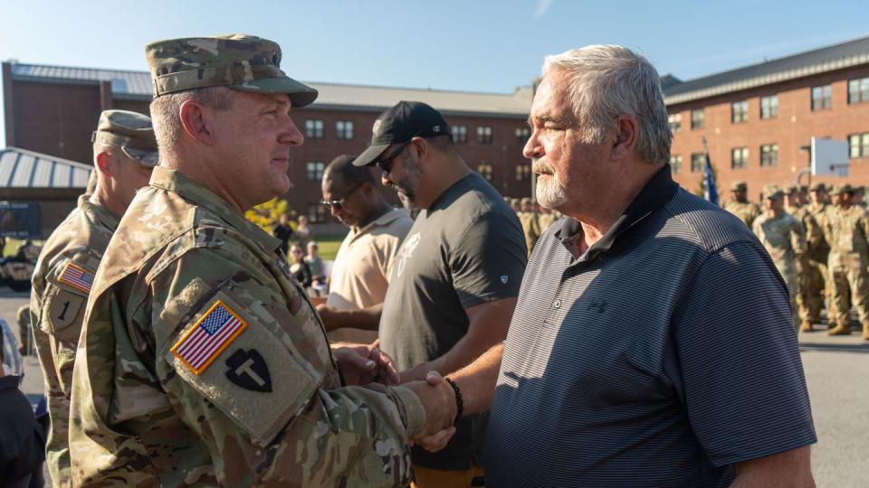 Lt. Col. John Suprynowicz, left,  shakes hands with former platoon mate, retired Sgt. 1st Class Thomas Mooney, right. Thirty years after Black Hawk Down, the 10th Mountain Division, 1st Brigade Combat Team, 1-87 Infantry Battalion honors 3rd Platoon, Charlie Company veterans for their heroics during the Battle of Mogadishu. (Spc. Kasimir Jackson/Army)