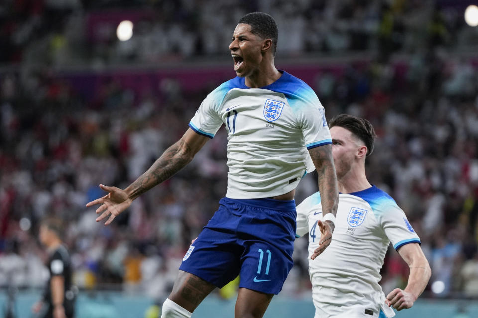 England's Marcus Rashford celebrates after scoring the opening goal during the World Cup group B soccer match between England and Wales, at the Ahmad Bin Ali Stadium in Al Rayyan , Qatar, Tuesday, Nov. 29, 2022. (AP Photo/Frank Augstein)