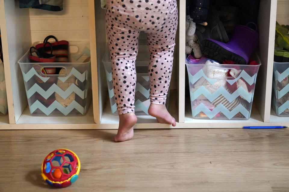 A preschooler gets up on her toes to reach into her assigned cubby at a preschool center Monday, Oct. 25, 2021, in Mountlake Terrace, Wash. Child care centers once operated under the promise that it would always be there when parents have to work. Now, each teacher resignation, coronavirus exposure, and day care center closure reveals an industry on the brink, with wide-reaching implications for an entire economy's workforce. (AP Photo/Elaine Thompson)