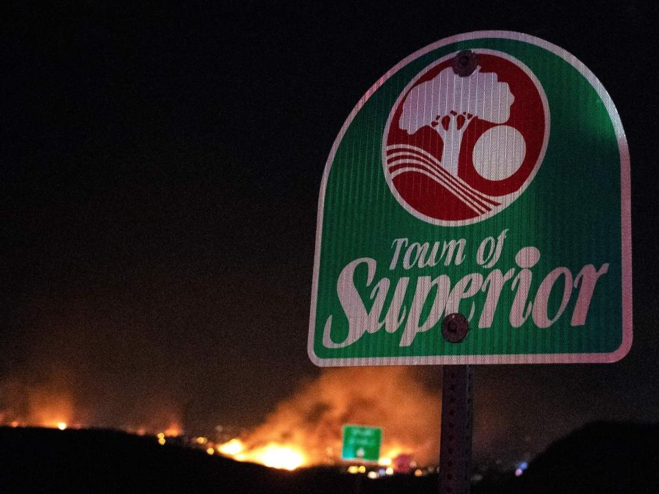 Fires ablaze behind a Town of Superior sign in Colorado.