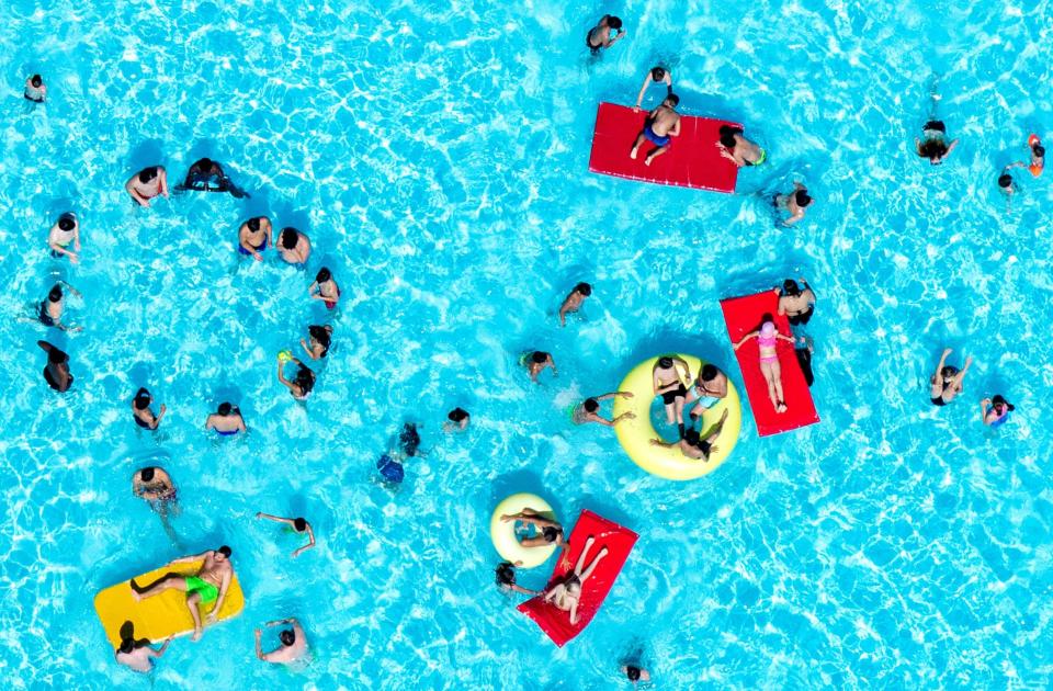 People cool off in a swimming pool in Hannover, western Germany (AFP/Getty Images)