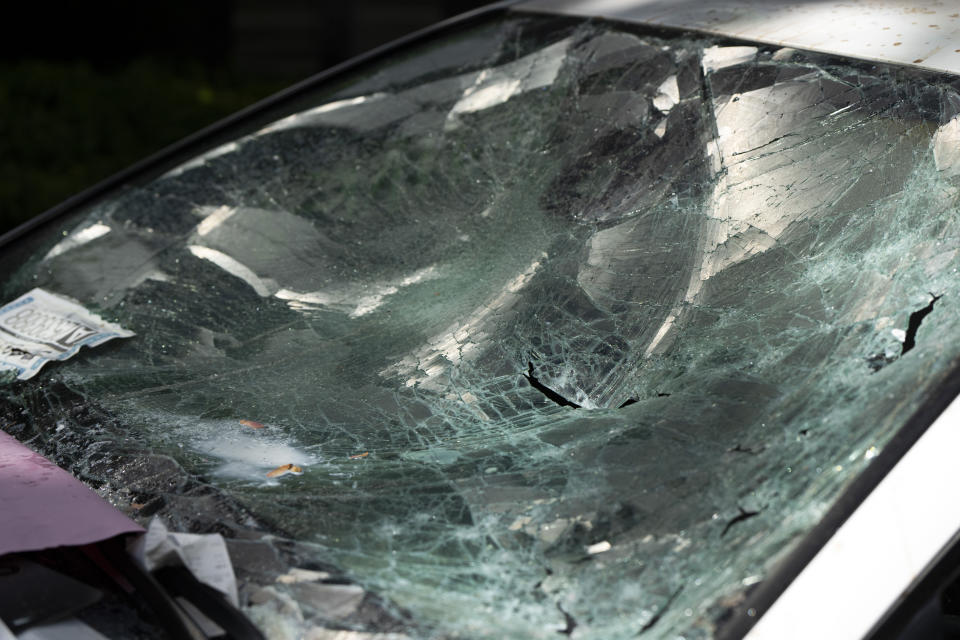 A car that atrempted to drive through a crowd of pro-Palestinian protesters on the Portland State University campus is seen parked and damaged on a campus walkway on Thursday, May 2, 2024, in Portland, Ore. After the driver fled on foot the protesters damaged the car. (AP Photo/Jenny Kane)