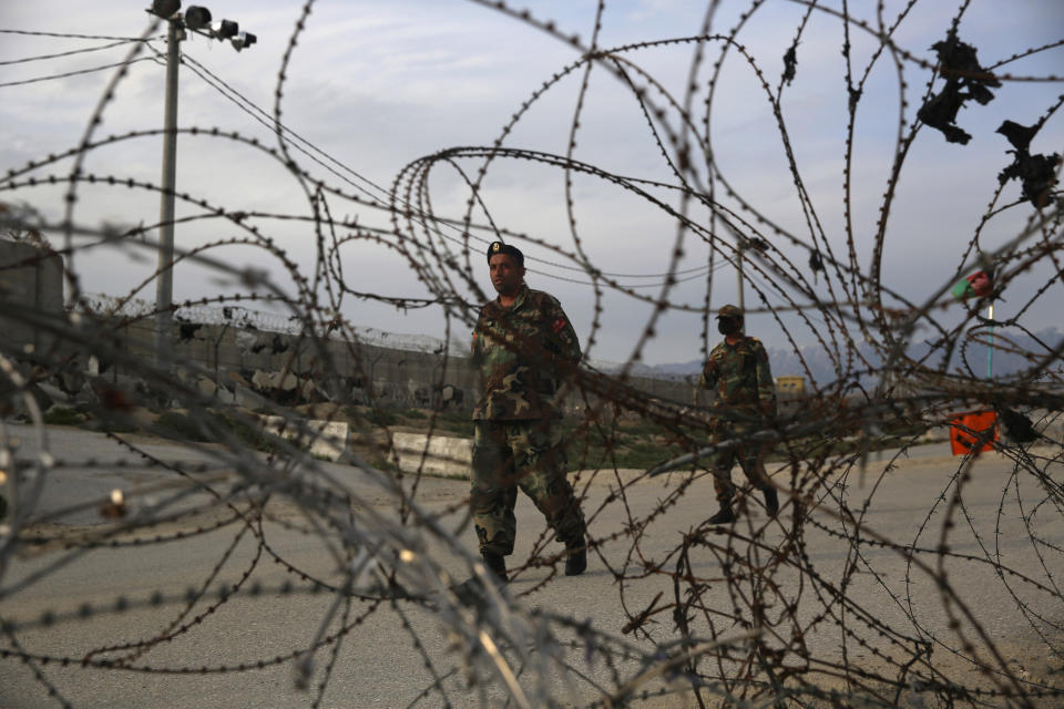 Afghan National Army soldiers stand guard at a checkpoint near the Bagram base in northern Kabul, Afghanistan, Wednesday, April 8, 2020. An Afghan official said Wednesday that the country has released 100 Taliban prisoners from Bagram, claiming they are part of 5,000 detainees who are to be freed under a deal between insurgents and U.S. But the Taliban says they have yet to verify those released were on the list they had handed over to Washington during negotiations. (AP Photo/Rahmat Gul)