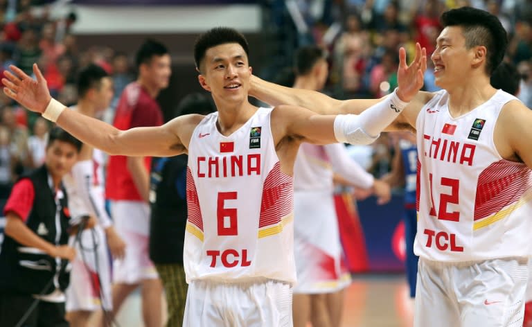 Guo Ailun (L) of China celebrates with teammate Li Gen after beating the Philippines during their FIBA Asia Basketball championship final match, in Changsha, Hunan province, on October 3, 2015