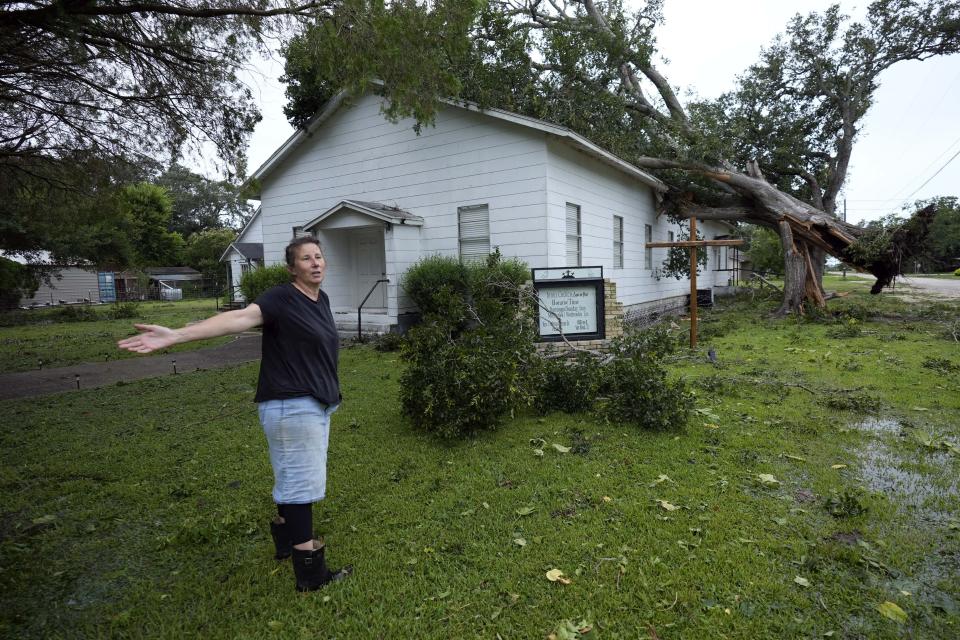 Ann McCauley examines the damage at Bethel Church after Hurricane Beryl moved through the area, Monday, July 8, 2024, in Van Vleck, Texas. (AP Photo/Eric Gay)