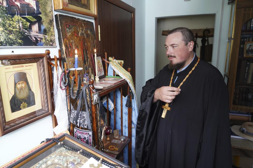 The Rev. Iakov Vorontsov crosses him at his apartment in Almaty, Kazakhstan on Wednesday, Aug. 9, 2023. Vorontsov, a priest in Kazakhstan, was shocked and desperate when he first heard that Russia sent troops into Ukraine. He was hoping the church would step in to mediate the conflict. But his calls to preach peace received no support: his superiors reassigned him several times, forbade him from giving sermons, and told parishioners to stay away from him. In the end, Vorontsov decided to temporarily stop serving. (Vladimir Tretyakov/NUR.KZ via AP)