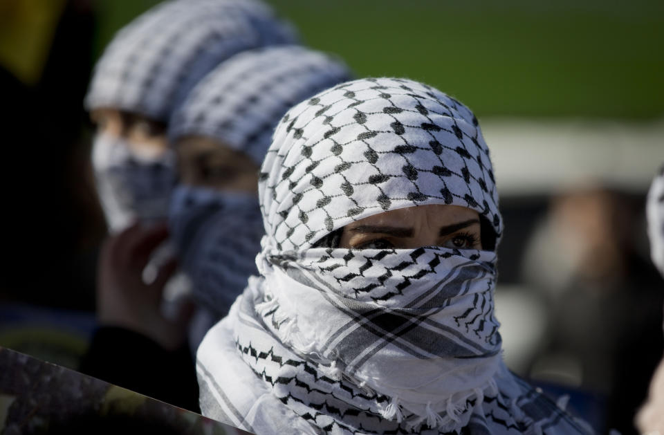 Palestinians women march during a celebration marking the 55th anniversary of the Fatah movement, in the West Bank city of Ramallah, Tuesday, Dec. 31, 2019. (AP Photo/Majdi Mohammed)