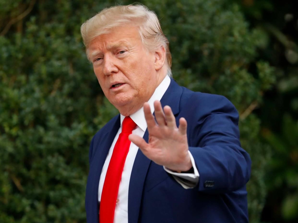 President Donald Trump looks towards members of the media on the South Lawn of the White House: AP