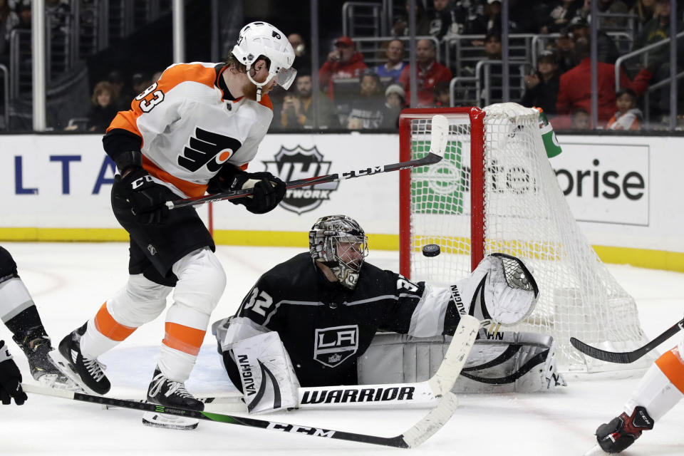 Los Angeles Kings goaltender Jonathan Quick (32) stops a shot next to Philadelphia Flyers' Jakub Voracek during the third period of an NHL hockey game Tuesday, Dec. 31, 2019, in Los Angeles. (AP Photo/Marcio Jose Sanchez)